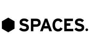 Logo of SPACES, featuring a hexagonal shape and modern typography, representing a brand focused on flexible workspace solutions.